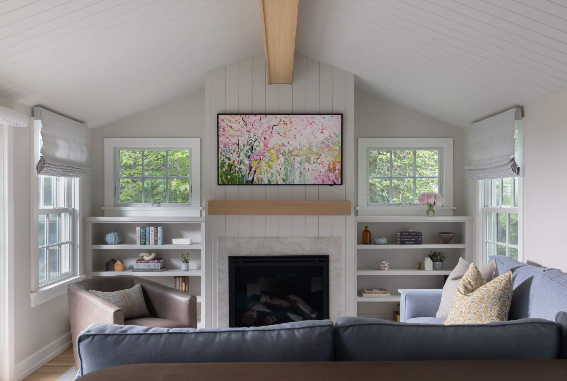 Living room with vaulted shiplap ceiling, fireplace and built-ins